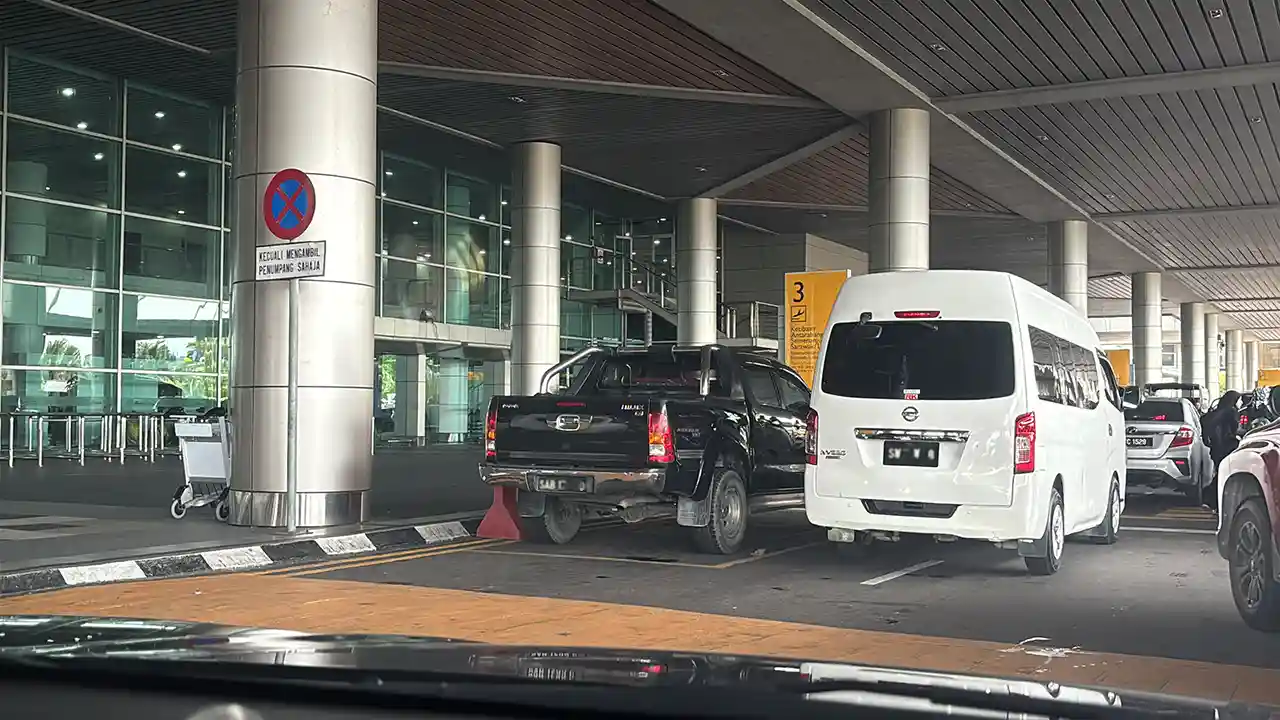 Grab car and van watiing for passengers at Tawau airport and going to Semporna