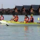 Chinese tourists enjoying a peaceful paddle in a sea kayak on the crystal-clear turquoise ocean in front of Kapalai resort.